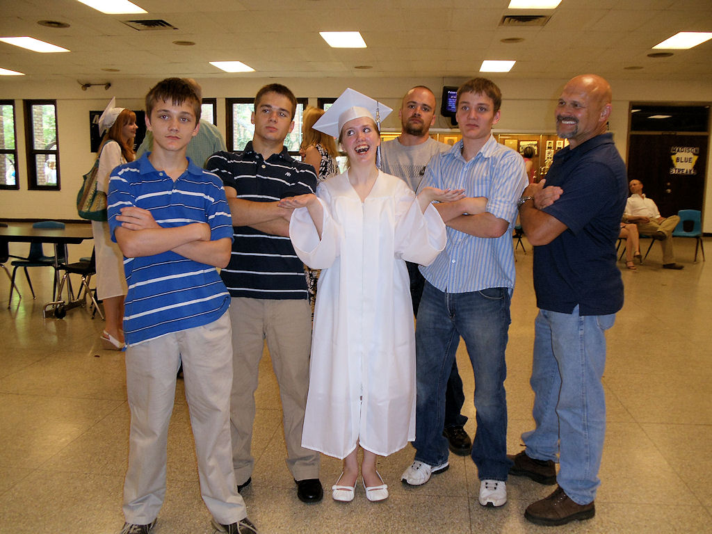 Joy with her dad and brothers on graduation day